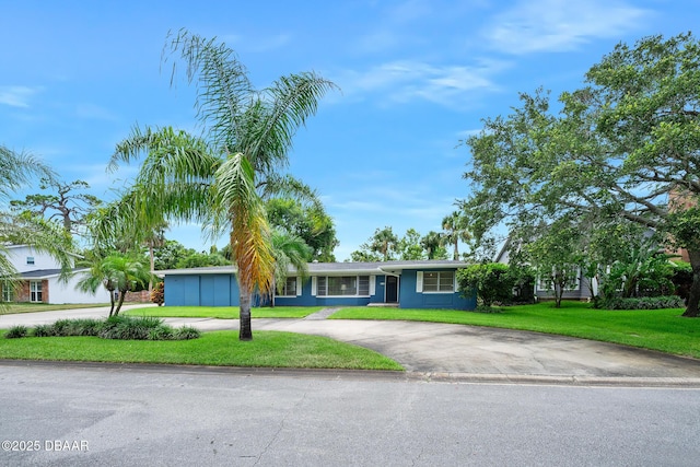 49 Bosarvey Cir, Ormond Beach, FL 32176 - ranch-style house featuring curved driveway and a front lawn