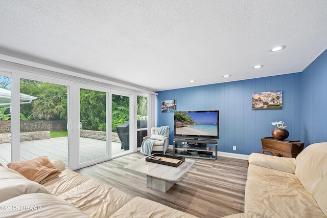 49 Bosarvey Cir, Ormond Beach, FL 32176 - living room featuring wood finished floors, a textured ceiling, and recessed lighting