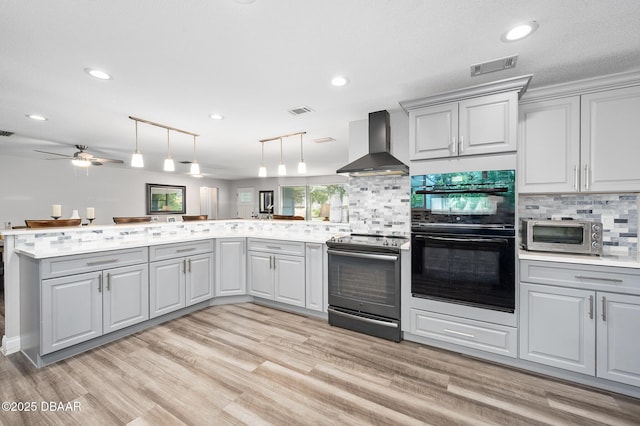 49 Bosarvey Cir, Ormond Beach, FL 32176 - kitchen featuring range with electric cooktop, wall chimney range hood, a peninsula, gray cabinets, and light countertops