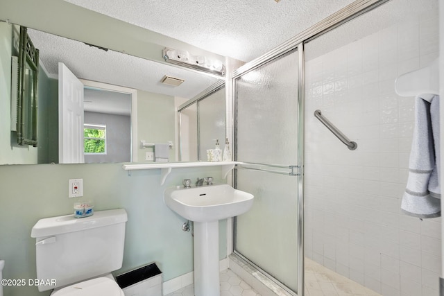 49 Bosarvey Cir, Ormond Beach, FL 32176 - full bathroom featuring a textured ceiling, a stall shower, and tile patterned floors