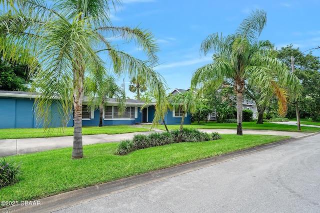 49 Bosarvey Cir, Ormond Beach, FL 32176 - view of front of house featuring curved driveway and a front yard