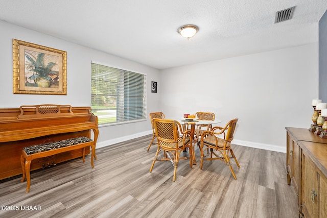 49 Bosarvey Cir, Ormond Beach, FL 32176 - dining room with wood finished floors and a textured ceiling