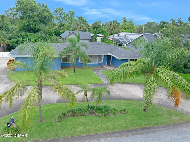 49 Bosarvey Cir, Ormond Beach, FL 32176 - view of front of house featuring a front lawn, a shingled roof, and stucco siding