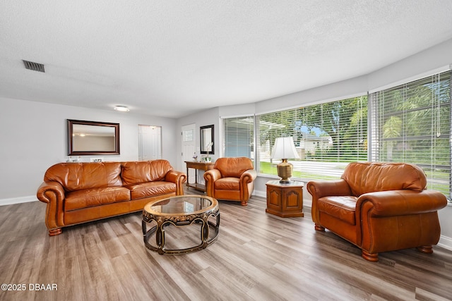 49 Bosarvey Cir, Ormond Beach, FL 32176 - living area featuring a textured ceiling and wood finished floors