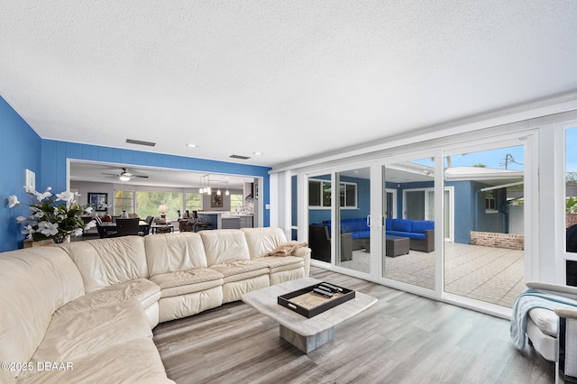 49 Bosarvey Cir, Ormond Beach, FL 32176 - living area featuring a textured ceiling, wood finished floors, and ceiling fan