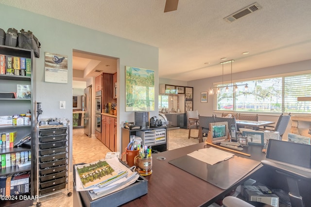 home office featuring wine cooler, a textured ceiling, and light tile patterned floors