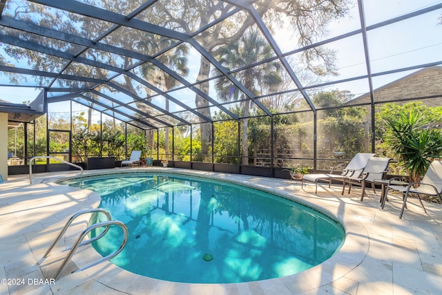 view of pool featuring a patio and a lanai