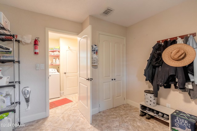 mudroom featuring light tile patterned flooring and washer / dryer