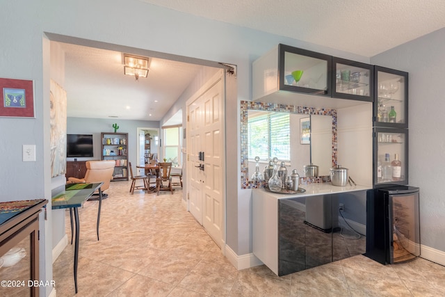 interior space featuring light tile patterned flooring and a textured ceiling