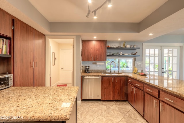 kitchen featuring french doors, light stone counters, light tile patterned flooring, sink, and stainless steel dishwasher