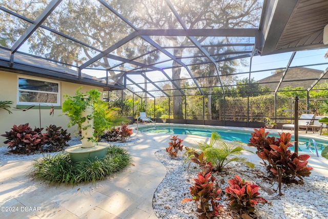 view of pool with a lanai and a patio