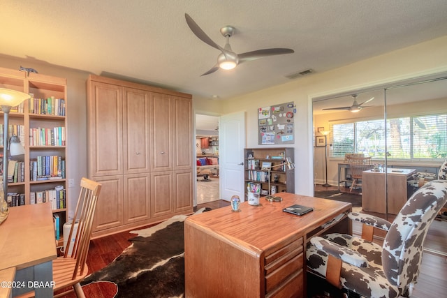 office space with dark hardwood / wood-style flooring, a textured ceiling, and ceiling fan