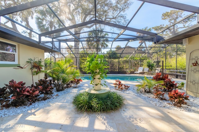 view of pool featuring glass enclosure and a patio area