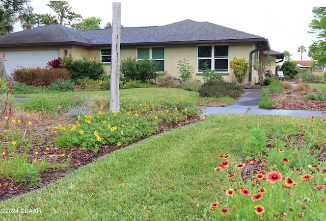 view of property exterior with a lawn and a garage