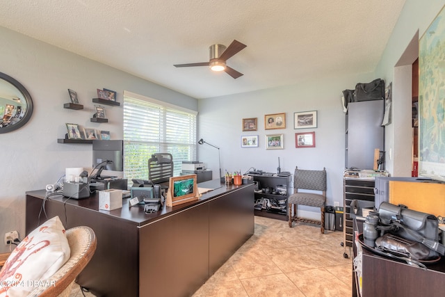 office area with a textured ceiling, ceiling fan, and light tile patterned floors