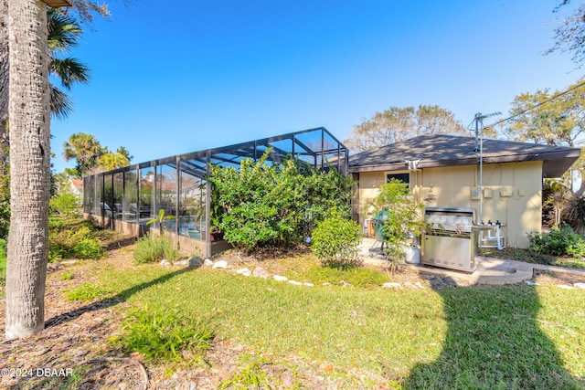 view of yard with glass enclosure