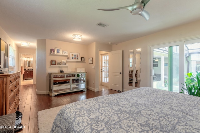 bedroom with dark wood-type flooring, access to outside, multiple windows, and ceiling fan