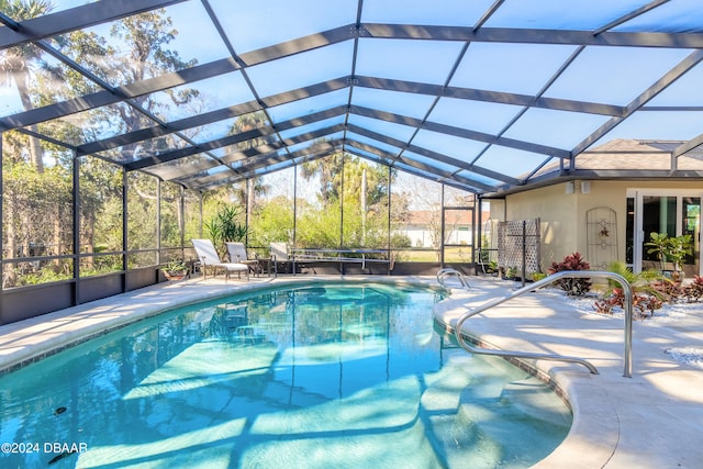 view of swimming pool featuring a lanai and a patio area