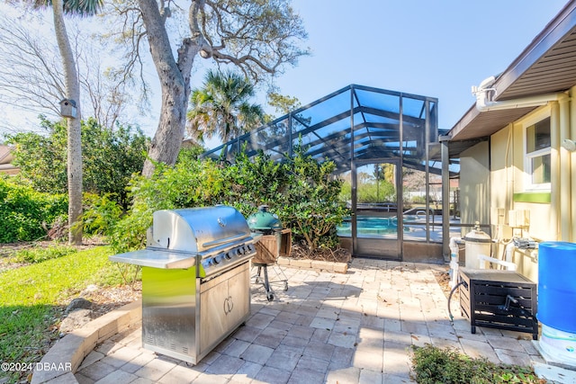 view of patio / terrace featuring a lanai, an outdoor kitchen, grilling area, and a pool