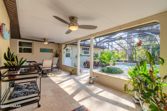 sunroom featuring ceiling fan