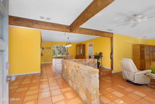 tiled living room featuring a textured ceiling, ceiling fan, and beamed ceiling