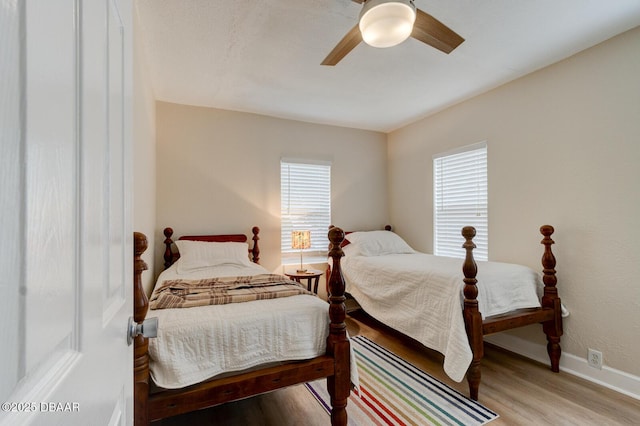 bedroom with ceiling fan and light wood-type flooring