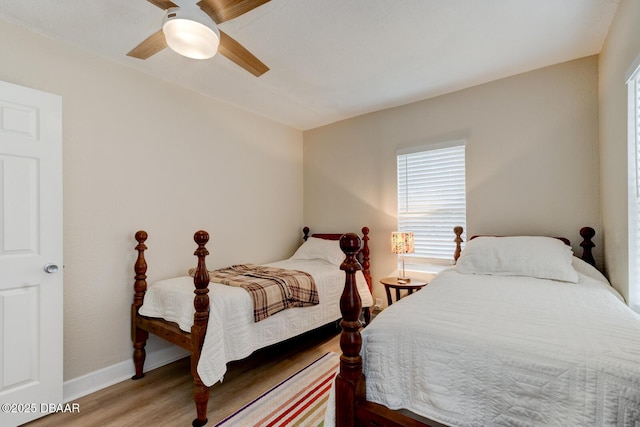 bedroom with wood-type flooring and ceiling fan