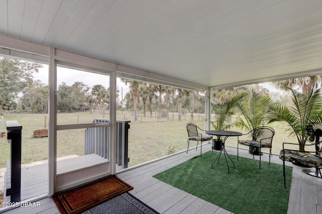 sunroom / solarium with wood ceiling and a healthy amount of sunlight