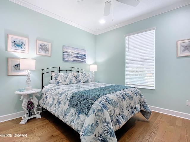 bedroom featuring hardwood / wood-style flooring, ceiling fan, and crown molding