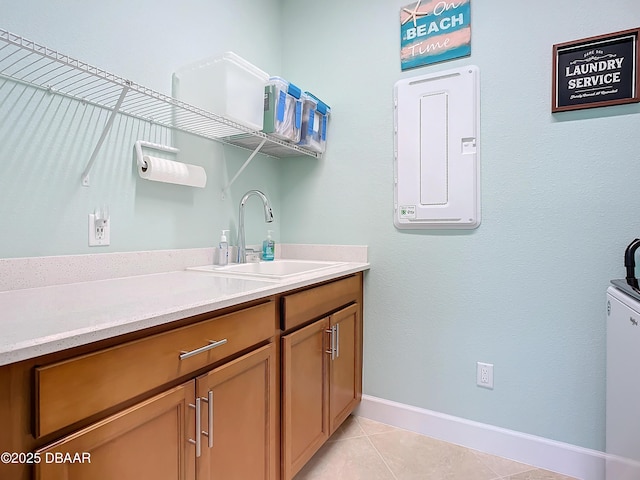 laundry area with light tile patterned flooring and sink