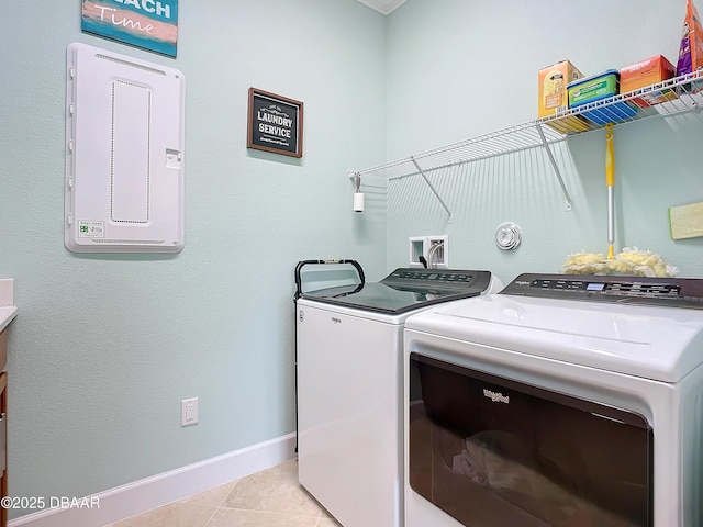 washroom with light tile patterned floors and washer and clothes dryer