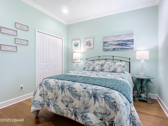 bedroom with crown molding, a closet, and wood-type flooring