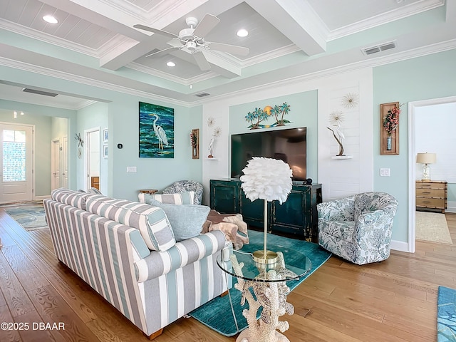 living room featuring beam ceiling, light hardwood / wood-style floors, and ornamental molding