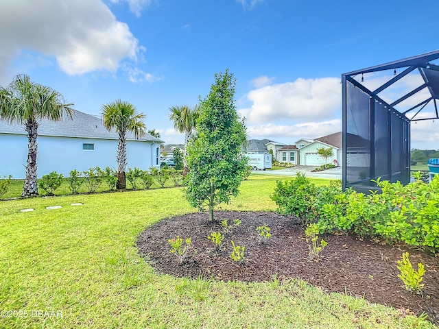 view of yard featuring glass enclosure