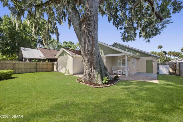 3457 Martingale Ct, Port Orange, FL 32129 - fenced backyard featuring a ceiling fan and a patio area