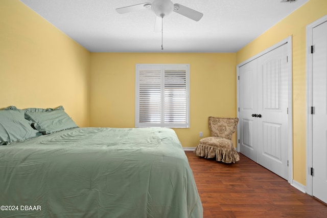 bedroom with ceiling fan and dark hardwood / wood-style floors