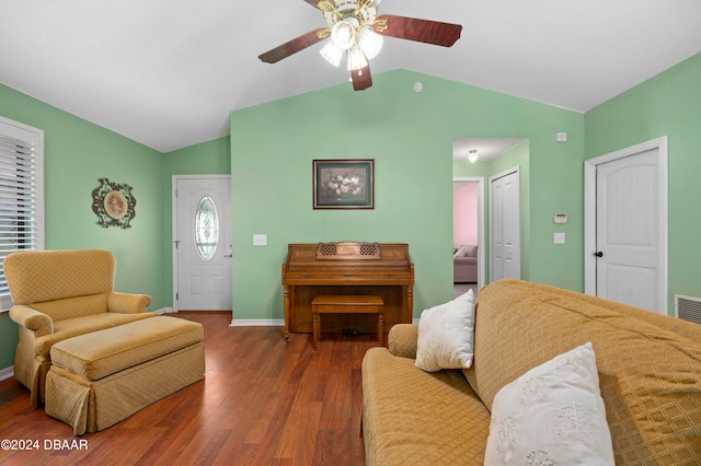 living room featuring ceiling fan, dark hardwood / wood-style floors, and vaulted ceiling