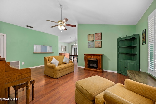 living room featuring lofted ceiling, dark hardwood / wood-style floors, and ceiling fan