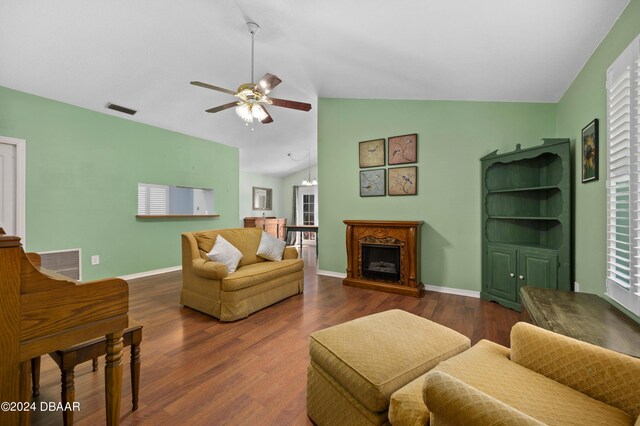 3457 Martingale Ct, Port Orange, FL 32129 - living room with vaulted ceiling, ceiling fan, wood finished floors, and a fireplace with raised hearth