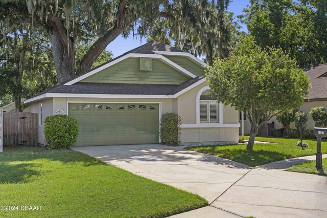 3457 Martingale Ct, Port Orange, FL 32129 - view of front facade with a shingled roof, an attached garage, driveway, and stucco siding