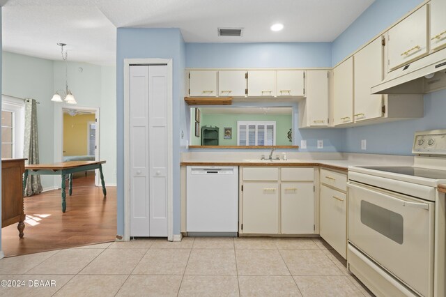 3457 Martingale Ct, Port Orange, FL 32129 - kitchen featuring white appliances, under cabinet range hood, cream cabinets, light countertops, and recessed lighting