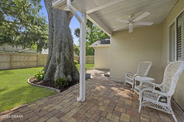 3457 Martingale Ct, Port Orange, FL 32129 - fenced backyard with a ceiling fan and a patio area
