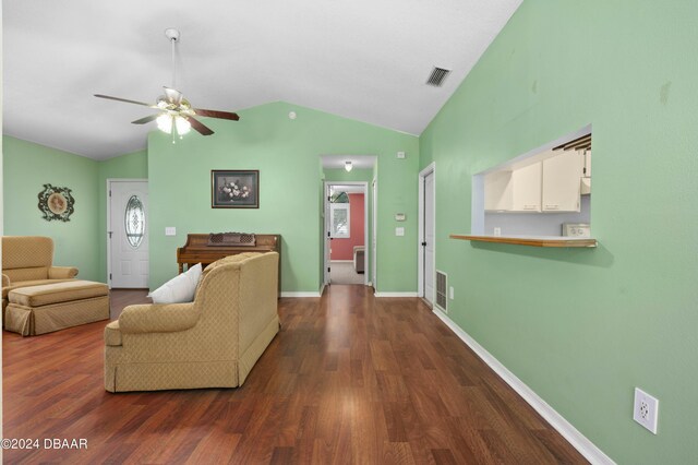 3457 Martingale Ct, Port Orange, FL 32129 - living room featuring vaulted ceiling, a ceiling fan, and dark wood-type flooring