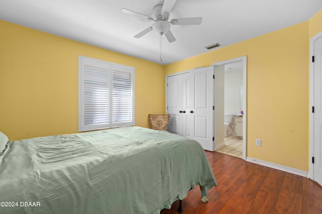 bedroom featuring a closet, a textured ceiling, dark hardwood / wood-style floors, ceiling fan, and ensuite bathroom