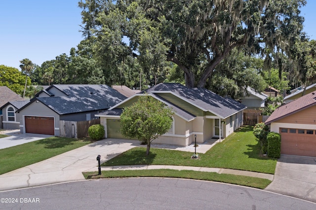 view of front of home with a garage and a front lawn