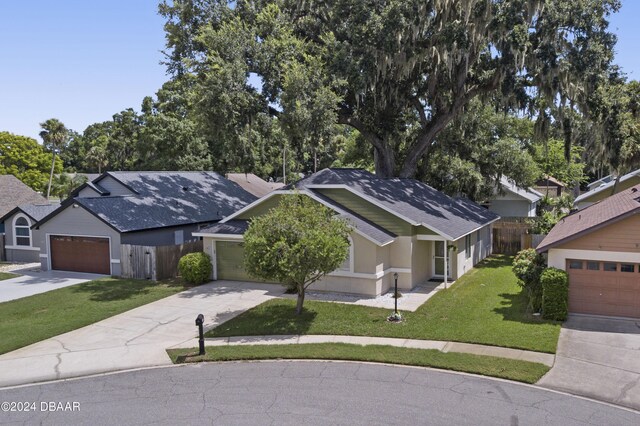 3457 Martingale Ct, Port Orange, FL 32129 - ranch-style house featuring concrete driveway, roof with shingles, a garage, and stucco siding