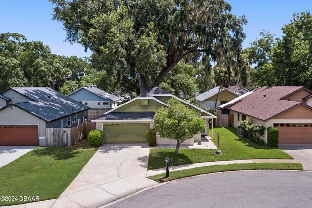 view of front of property with a front lawn and a garage