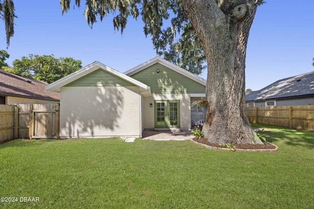 3457 Martingale Ct, Port Orange, FL 32129 - back of house featuring french doors, a fenced backyard, and stucco siding