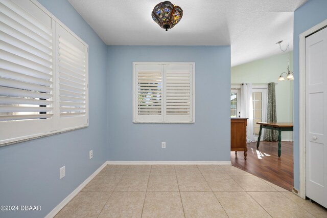 3457 Martingale Ct, Port Orange, FL 32129 - spare room with healthy amount of natural light, tile patterned flooring, and a chandelier