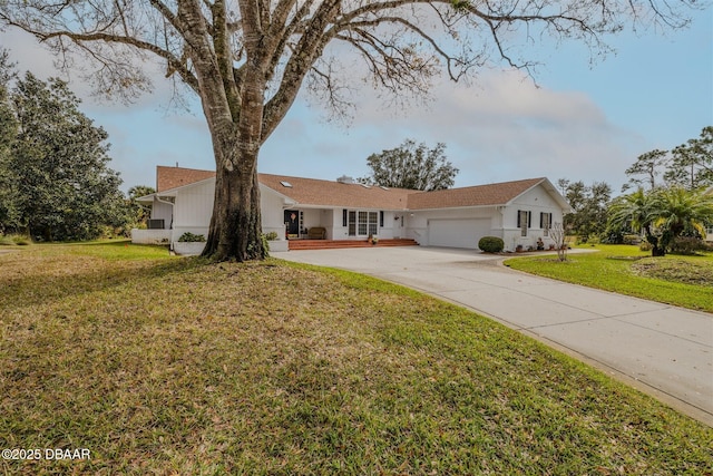 single story home featuring a garage and a front lawn